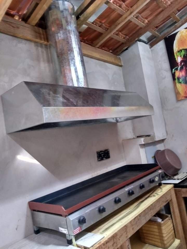 Food truck exhaust hood installed above commercial cooking equipment